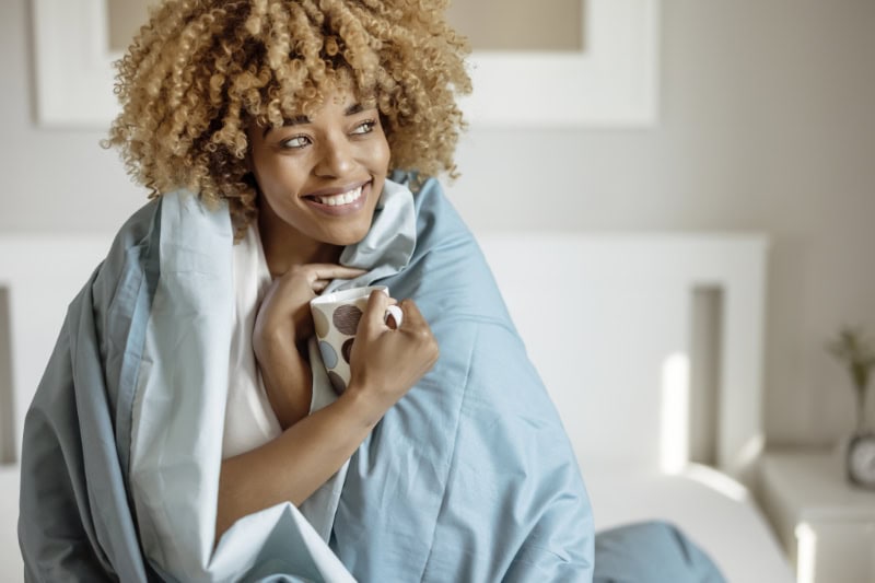 Woman wrapped up in blanket.
