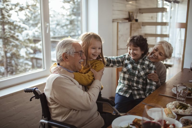 How to Lower Your Winter Heating Bill. Close up of a family enjoying a meal together.