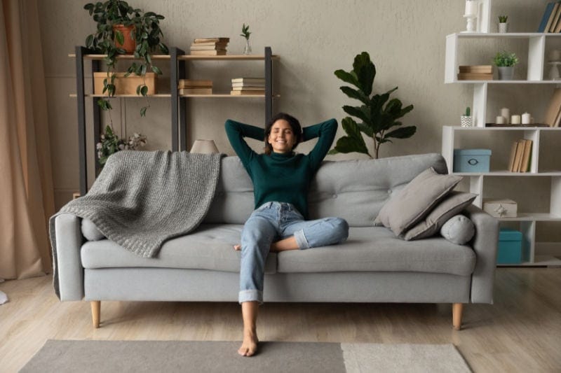 Woman sitting comfortably in her home.