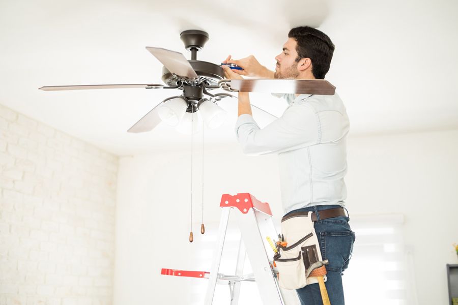 Image of someone working on a fan. Think HVAC During Your Home Remodeling.