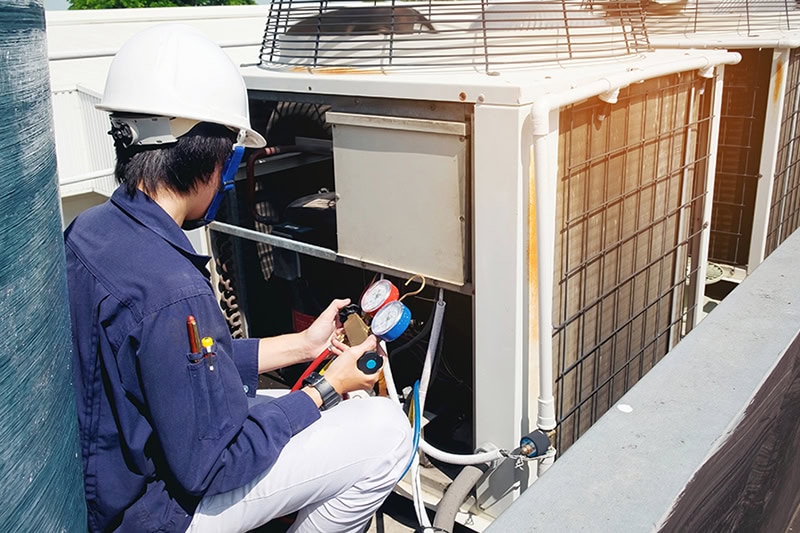 Technician working on outdoor unit.