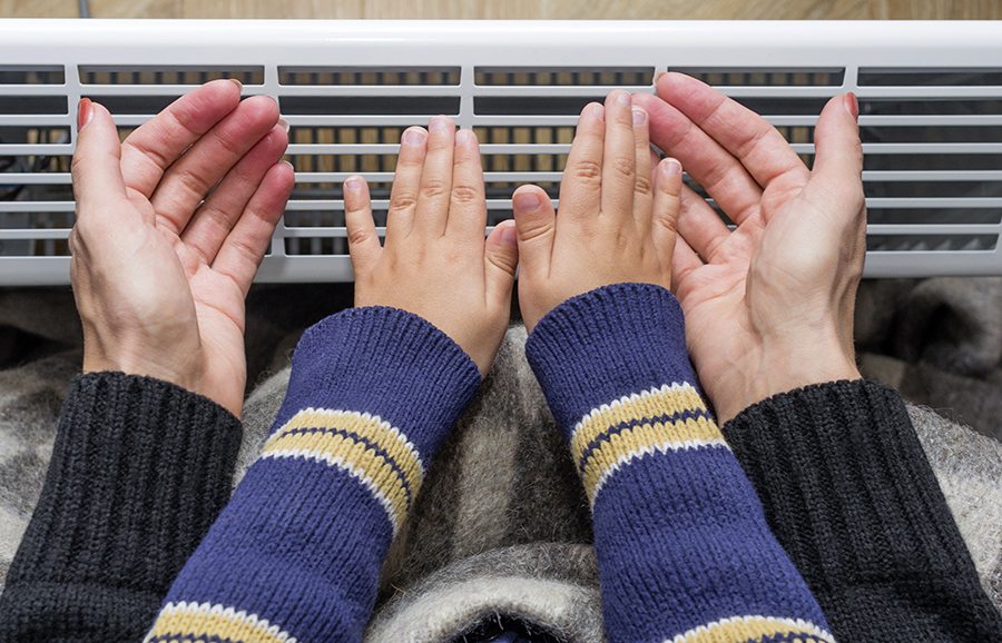 Hands up to a furnace