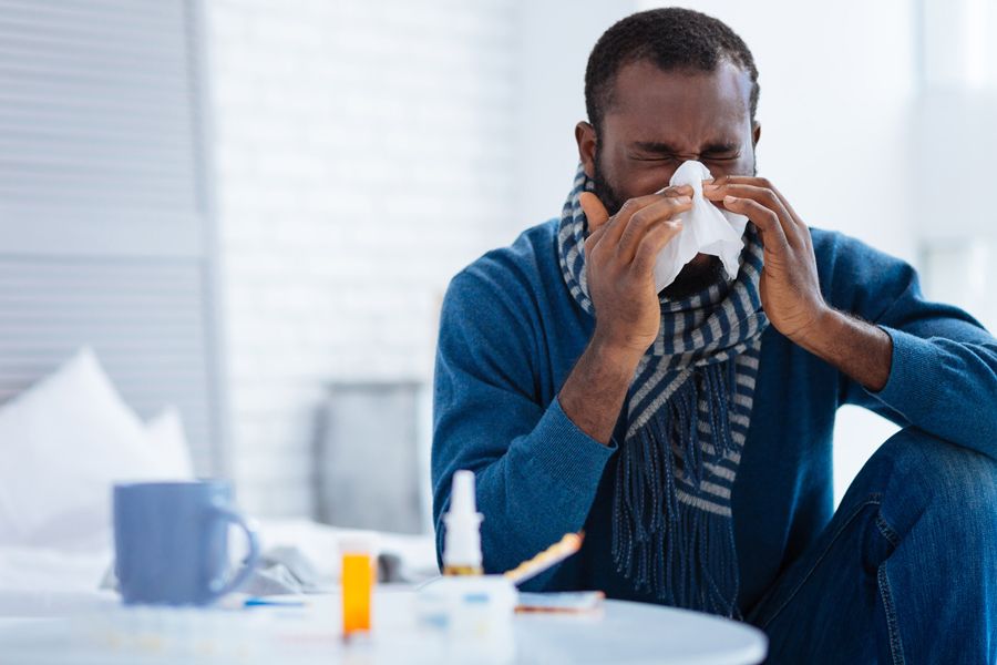 The Basics of Winter Indoor Air Quality. Image shows man wearing a scarf